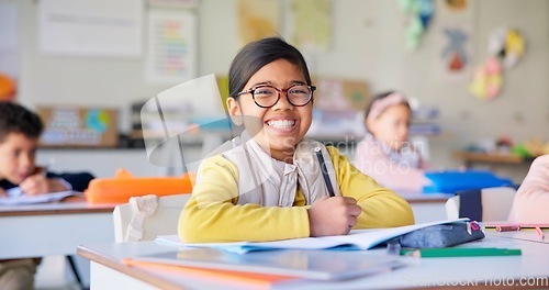 Image of Smile, learning and study with girl in classroom for education, knowledge and writing. Scholarship, happy and future with portrait of young student at school for academy, exam test and project