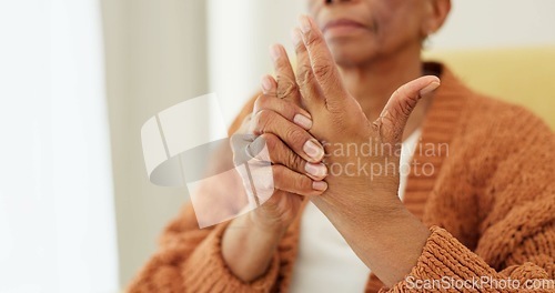 Image of Hands, pain and arthritis with an elderly woman in her nursing home, struggling with a medical injury or problem. Healthcare, ache or carpal tunnel with a senior resident in an assisted living house