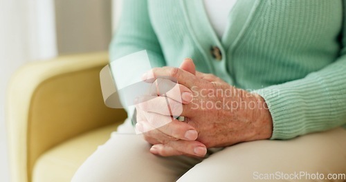 Image of Hands, anxiety and senior woman on a sofa with stress, fear or grief, dementia or scared in her home. Stress, worry and nervous elderly female in a living room with Alzheimer, arthritis or depression