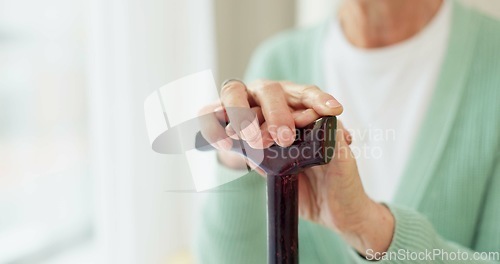 Image of Cane, retirement and support with hands of old woman for cancer, medical and person with a disability. Rehabilitation, healthcare and walking stick with closeup of person in nursing home for balance