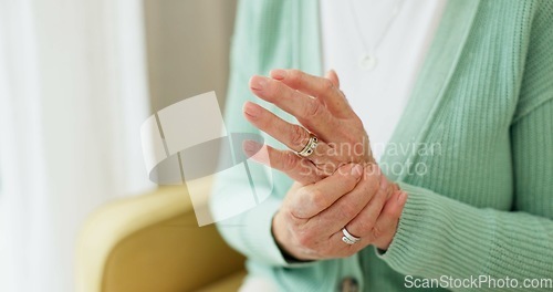 Image of Hands, pain and arthritis with a senior woman in her nursing home, struggling with a medical injury or problem. Healthcare, ache or carpal tunnel with an elderly resident in an assisted living house