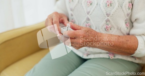 Image of Sick, medicine and hands of person on the sofa for routine medical supplement in a house. Closeup, daily and a woman with pills, tablet or vitamin c for healthcare on the living room couch of a home