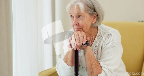 Image of Senior woman, cane and thinking on home sofa to remember memory and relax in retirement. Serious and sad elderly person or old lady with a disability at nursing facility with Alzheimer and depression