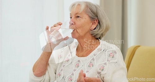 Image of Water, pills and senior woman on a sofa with medicine for health, balance and aging wellness in her home. Tablet, swallow and elderly lady in living room with vitamin c, collagen or iron and calcium