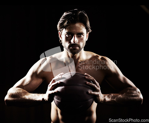 Image of Muscle, body and portrait of man with basketball in studio isolated on black background. Sports, serious face and strong athlete with ball, abs or workout, fitness or training to exercise for health