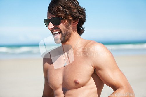 Image of Summer, funny and the body of a man on the beach for travel, freedom or adventure on vacation. Sand, shirtless and a young person laughing by the ocean or sea on a tropical coast for holiday