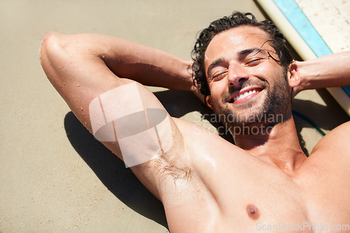 Image of Beach sand, happy man and face of relax surfer lying, sleep and tired after fitness training, fatigue or sports workout. Surfing happiness, eyes closed and top view person sleeping, smile and rest