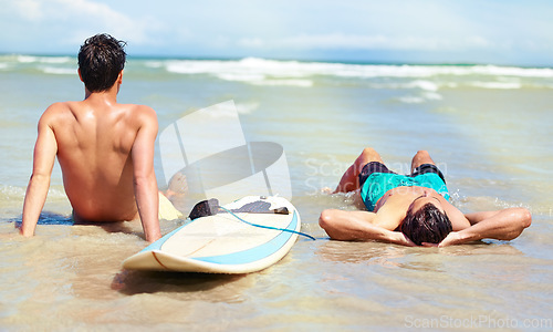 Image of Beach sports, relax people and surfer lying on sand, resting break from wellness activity, training or nature workout. Stress relief, sea water and outdoor surfing partner, friends or men on island