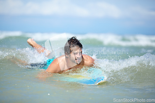 Image of Man, surfing and sea swimming with workout, training and waves with water sport and exercise outdoor of athlete. Surfer, freedom and vacation by the ocean and beach for summer wellness and fitness