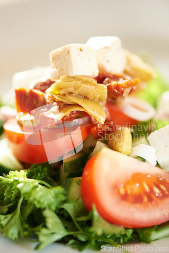 Image of Background, closeup and plate of healthy salad, food and nutrition for detox, lunch diet and eating in cafe. Appetizer, vegan cuisine or dining in restaurant for meal of leafy greens, tomato and feta