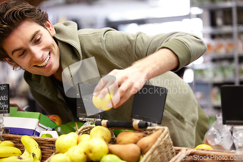 Image of Man, smile and fruit in grocery store for health diet, nutrition or shopping sale product. Male person, happy customer and apple choice in supermarket for organic vegan, quality price or fibre food