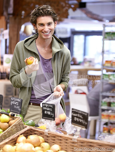 Image of Man, portrait and fruit shopping in grocery store for fibre nutrition, vegan food and healthy choice. Male person, smile and peach bag supermarket for organic health diet, vitamins or happy customer