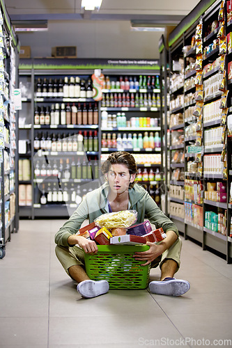 Image of Man, grocery shopping and shop, stress about inflation and expensive food, overwhelmed in supermarket. Groceries in basket, retail and customer shocked by price, choice and purchase with fear