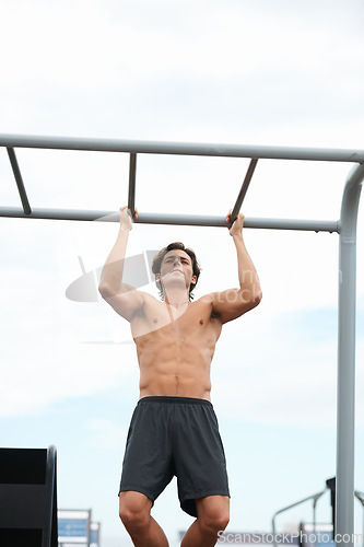 Image of Pull up bar, outdoor and man exercise for muscle building, body builder performance or strength development. Muscular, fitness training and strong athlete for workout, challenge or active practice