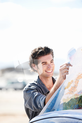 Image of Road map, car and young man with smile for weekend trip, vacation or holiday in countryside. Happy, vehicle and male person from Canada reading for travel, transport and outdoor adventure or journey.