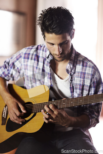 Image of Guitar, play and man in recording studio with musician writing music with creativity. Artist, talent and skill with playing a notes on instrument, strings and creative sound in jazz or songwriting