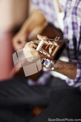 Image of Guitar, hands or man in home for music, performance or entertainment with sound, rhythm or talent. Learning solo, artist closeup or creative musician playing an instrument for artistic expression