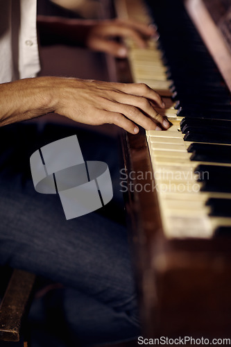 Image of Jazz, hands or man with piano for music, performance or learning solo for entertainment or freedom. Closeup, pianist or creative musician playing keys on instrument or organ for artistic expression