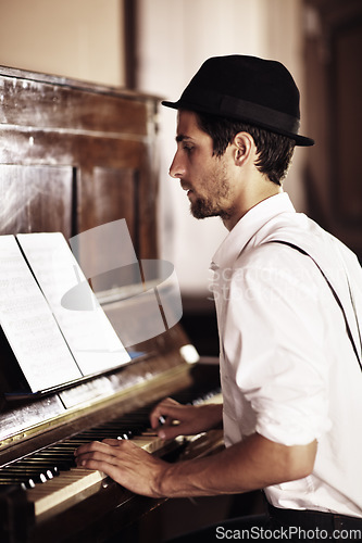 Image of Piano, reading or man playing music, performance or entertainment with talent, art or freedom. Learning solo, pianist or creative musician with keys on instrument or organ with paper or notes