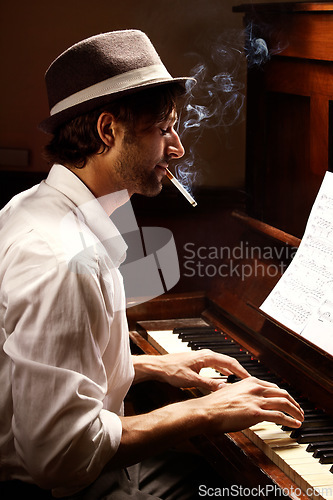 Image of Profile, piano and man with performance, smoking and entertainment with keyboard, jazz and creative. Person, artist and musician with cigarette, tobacco and ambient with smoke, pianist and instrument