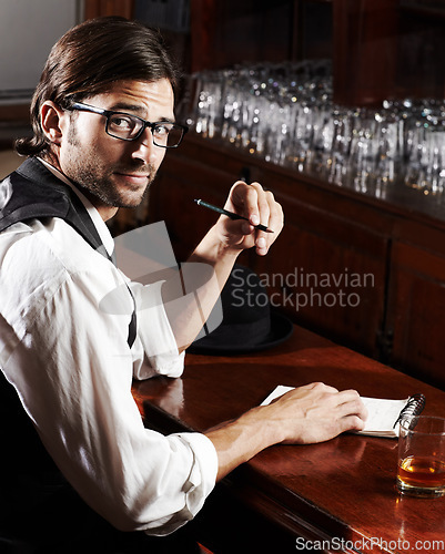 Image of Portrait, writer and man with a notebook, whiskey and creativity with inspiration, journalist and glasses. Face, person and author with alcohol, ideas and writing in a tavern, poet and freelancer