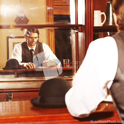 Image of Pub, whiskey and man writing, ideas and thinking with style, gentleman and inspiration with creativity. Person, writer and journalist with alcohol, notebook and pen with fashion, customer or planning