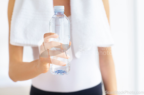 Image of Water bottle, hands or woman with health, fitness or wellness for hydration after exercise or training. Thirsty sports person, closeup or healthy athlete with liquid or aqua after workout to relax