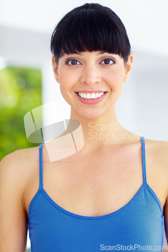 Image of Happy, smile and portrait of woman in a home with positive, good or confident attitude. Excited, happiness and young female model with optimistic, satisfaction or pride face in a modern house.