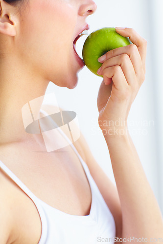 Image of Closeup, eating and woman with health, apple or wellness with detox on a white studio background. Person, girl or model with fruit, nutrition or hungry with diet plan, food or natural with digestion