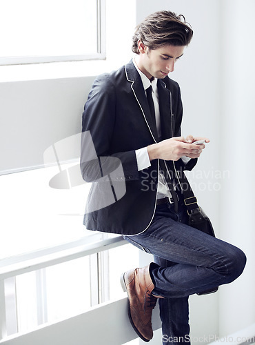 Image of Fashion, phone and young man networking on social media, mobile app or the internet with formal outfit. Business, technology and male person scroll on a cellphone with classy, cool and elegant style.