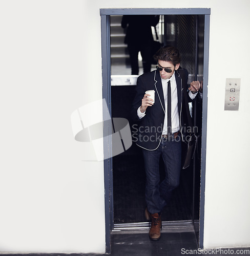 Image of Coffee, fashion and young man in a doorway with stylish, cool or formal classy outfit with confidence. Latte, style and male person from Canada with elegant jeans and blazer in a office building.
