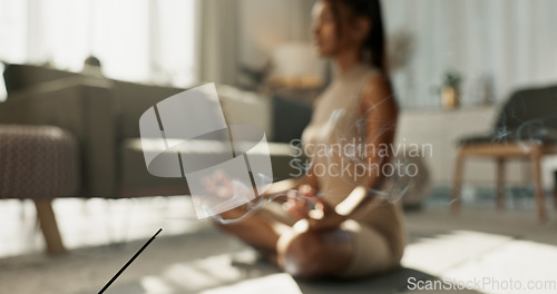 Image of Woman, yoga and incense on floor, lotus or peace for chakra balance, relax or breath in home living room. Girl, meditation or spiritual with zen, smoke or workout for wellness, fitness or mindfulness