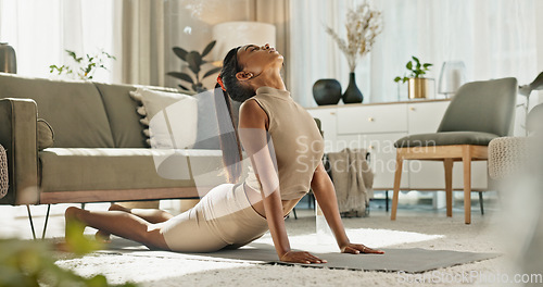 Image of Home, yoga and woman stretching back on floor in living room with peace in apartment. Holistic, exercise and girl workout for zen mindfulness, wellness and breathing for mental health or stress