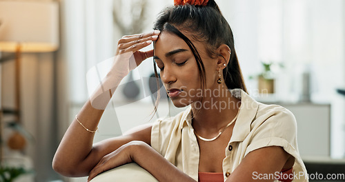 Image of Woman, depression and headache in living room for anxiety, mental health and stress of fatigue, mistake and debt at home. Pain, sad and frustrated indian person with trauma, broken heart and crisis