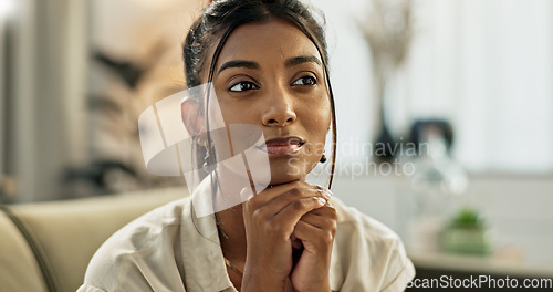 Image of Thinking, brainstorming and young woman on a sofa relaxing with an idea or memory in living room. Reflection, doubt and nervous Indian female person with decision in the lounge of modern apartment.