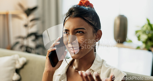 Image of Phone call, argument and young woman on a sofa for relaxing in the living room of apartment. Fighting, annoyed and Indian female person on mobile conversation with cellphone in lounge of modern home.