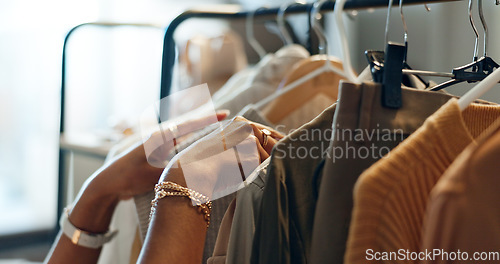 Image of Hands of designer, clothes rail or choice in studio, workshop or small business for sample, show or collection. Creative woman, closeup or decision for design, fabric or clothing fashion in store