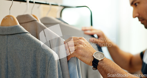 Image of Hands of man, clothing rack or choice in store for sample, tailor or collection in small business. Creative stylist, search or designer with decision for blazer design, suit fabric or fashion clothes