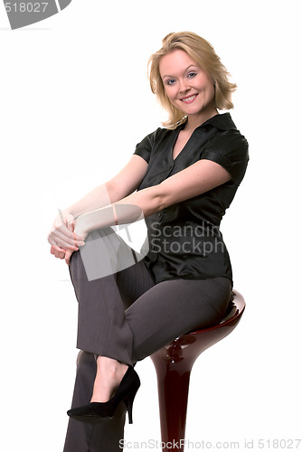 Image of Smiling woman sitting on stool