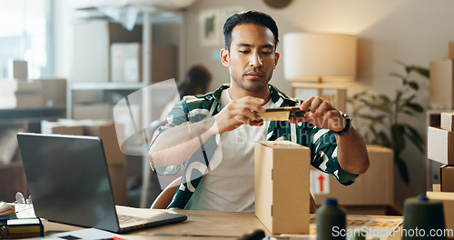 Image of Asian man, phone and box in logistics or small business for inventory inspection or pricing for ecommerce. Male person or store owner with mobile smartphone, laptop and boxes for picture scan