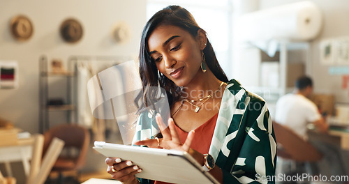 Image of Woman, typing and tablet in small business for fashion, shipping and planning supply chan schedule. Online shopping, app and employee with tech in workshop with retail inventory, stock or checklist