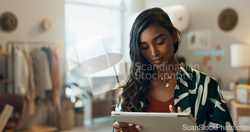 Image of Woman, typing and tablet in small business for fashion, shipping and planning supply chan schedule. Reading, store reviews or employee in online shopping workshop with retail inventory or checklist