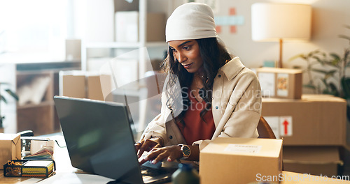 Image of Woman, laptop and typing in small business logistics for order, ecommerce or design at boutique. Female person, tailor or fashion designer on computer for inventory, storage or inspection at store