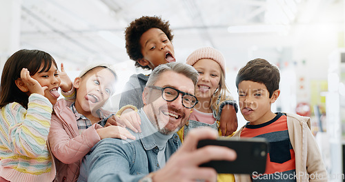 Image of Selfie, children and teacher with funny face, smile and picture with educator, excited and happy. Kids, internet and cellphone for technology, online and memories for school, classroom or diversity