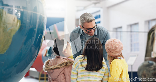 Image of Science, geography and kids learning about the earth with a teacher at school for growth or development. World, globe or planet with a man teaching students about climate change or global warming