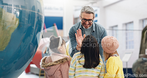 Image of Science, high five and students learning about the earth with a teacher at school for child development. Planet, support or motivation with a man teaching kids about climate change or global warming