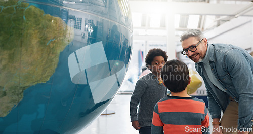 Image of Science, geography and students learning about the earth with a teacher at school for growth or development. World, globe or planet with a man teaching kids about climate change or global warming