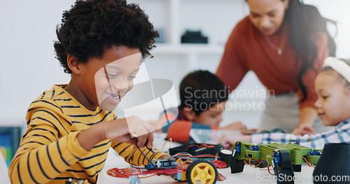 Image of Technology, boy and car robotics in classroom for learning, education or electronics with car toys for innovation. School kids, learners and transportation knowledge in science class for research