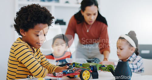 Image of Electronics, boy and car robotics in classroom for learning, education or technology with car toys for innovation. School kids, learners and transportation knowledge in science class for research