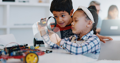 Image of Children, magnifying glass and classroom for robotics, education and learning for technology, science and school. Childhood, students or innovation with kids, studying or inspection project research